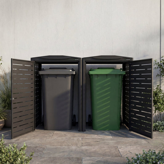 Three outdoor trash bins with covers in black and green, against a light gray wall.
